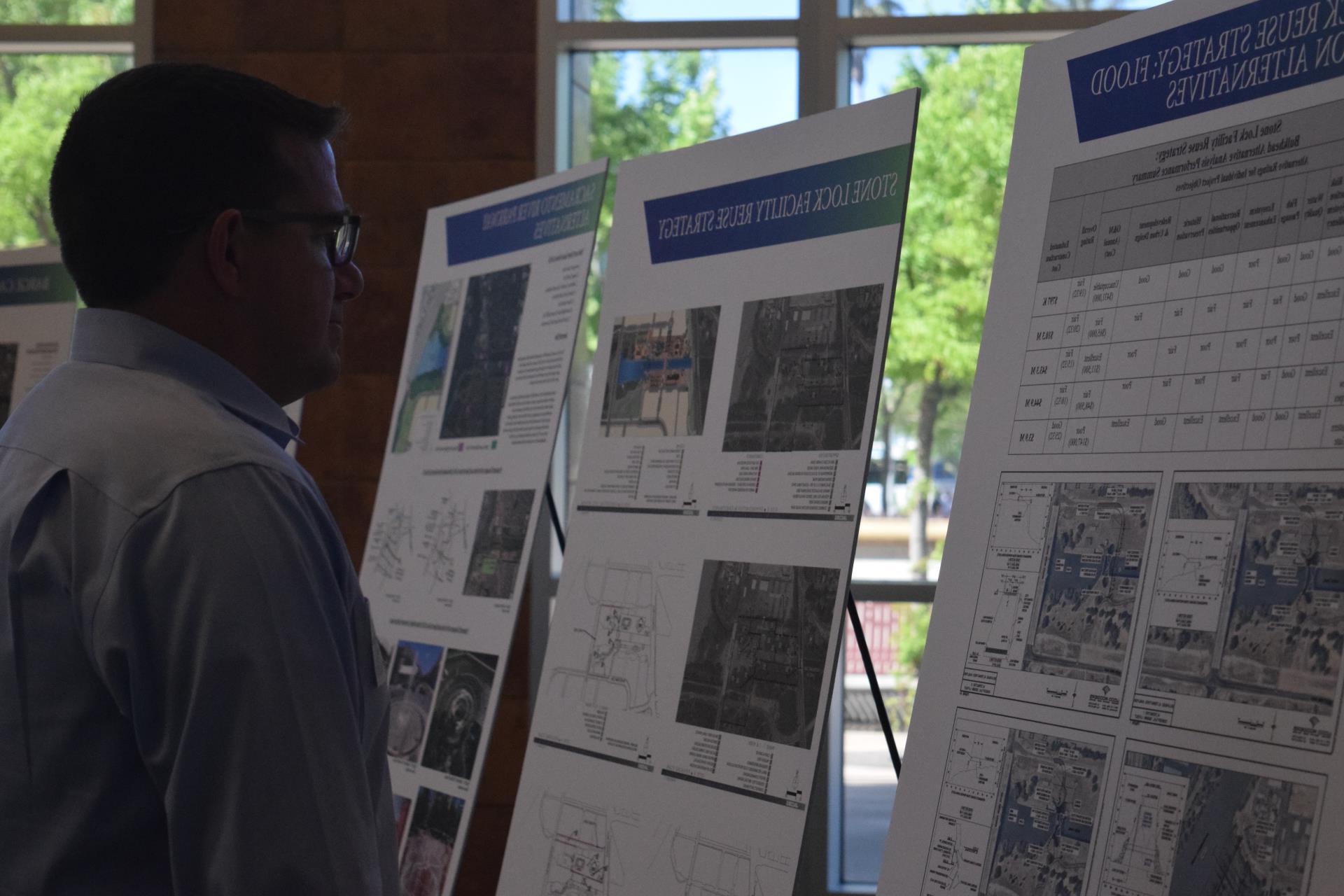 pioneer bluff open house resident reads display boards